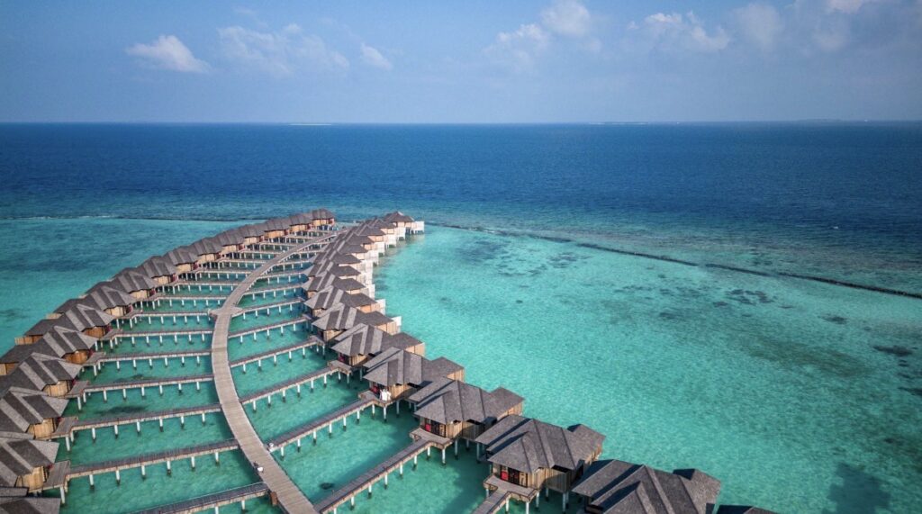 Luxury overwater villas in the Maldives surrounded by shallow turquoise lagoon and private island setting