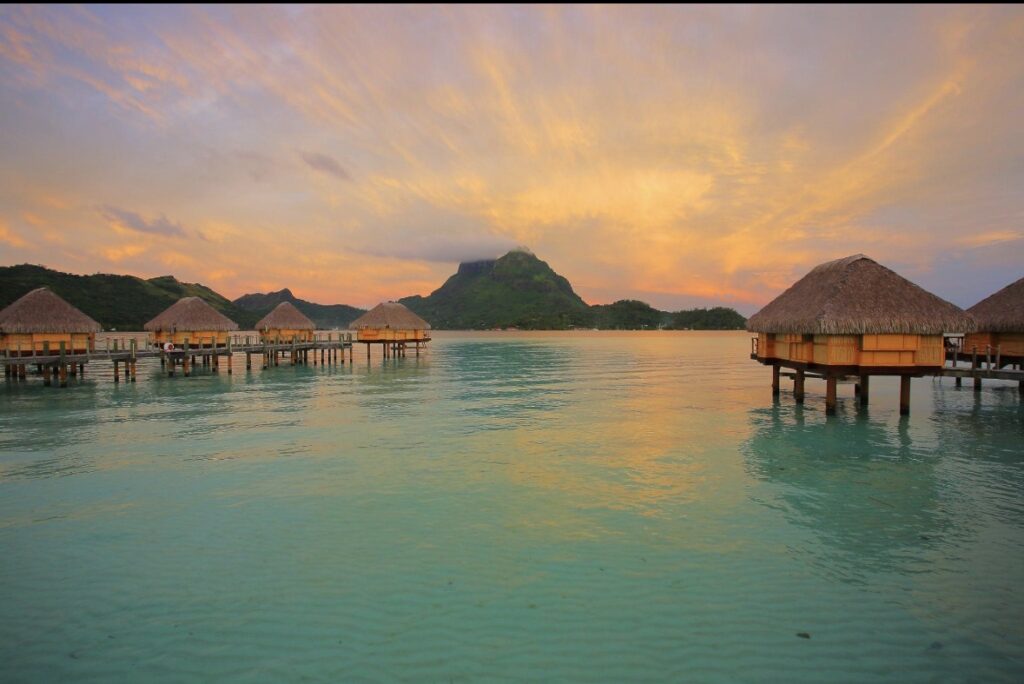Bora Bora overwater villas with Mount Otemanu and deep blue lagoon tropical scenery