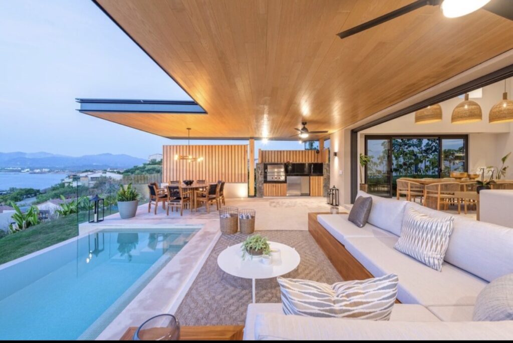 Modern luxury villa with private plunge pool, ocean view terrace, and outdoor dining area