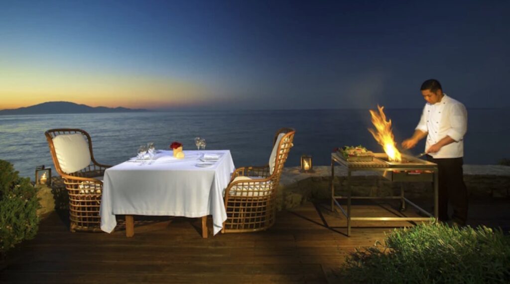 Private chef sunset dinner setup on oceanfront luxury villa terrace