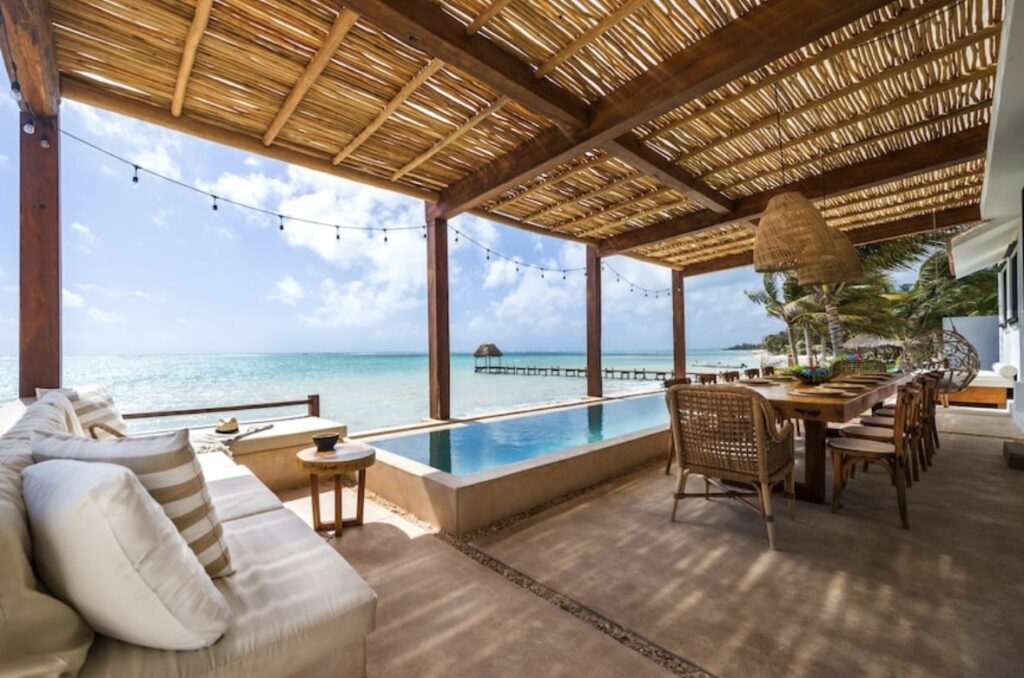 Spacious luxury villa in Tulum with open living area and pool view.