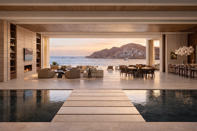 Luxury oceanfront villa in Cabo San Lucas with open-concept design and infinity pool at sunset
