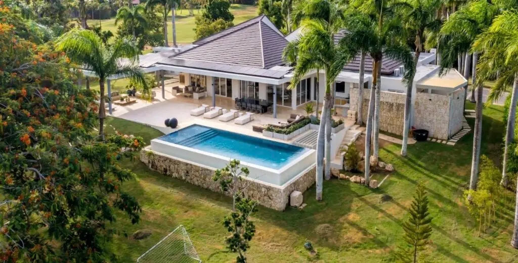 Exterior view of a luxury villa in Punta Cana with tropical landscaping