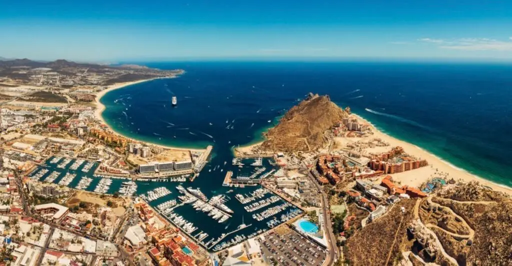 Aerial view of Cabo San Lucas coastline with turquoise water and sunny beach