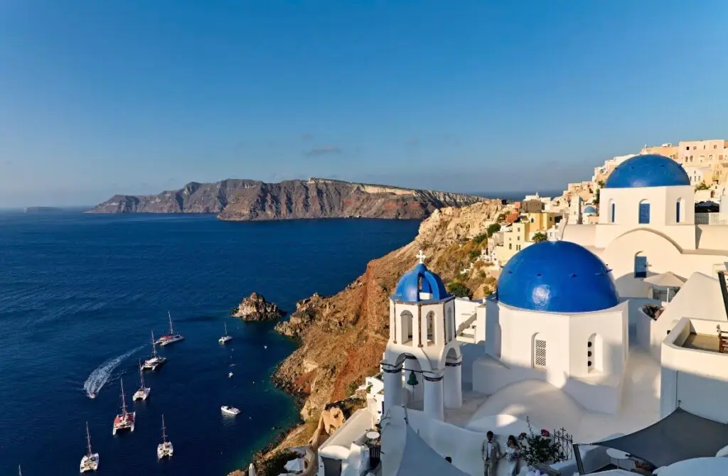 Santorini cliffside architecture with blue domes overlooking the Cadera
