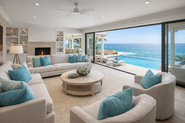 Luxury oceanfront villa living room in San Diego with floor-to-ceiling windows, infinity pool, and coastal views